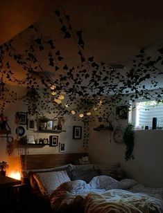 a bed room with a neatly made bed and lots of plants hanging from the ceiling