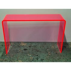 a red table sitting on top of a floor