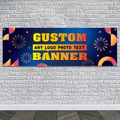 a custom banner hanging on a brick wall with fireworks and confetti in the background