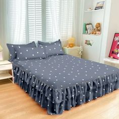 a bed with blue sheets and white polka dots