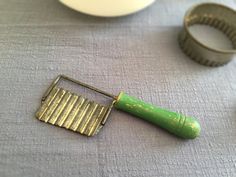 there is a small green toothbrush next to some cookie cutters