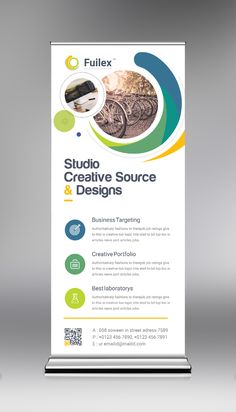 a roll up banner with the words studio creative source and designs on it, in front of a gray background