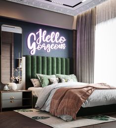 a bedroom with a green headboard and white bedding, along with a large mirror on the wall