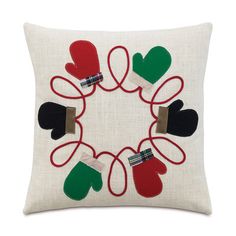 an embroidered pillow with mittens and gloves on it in the shape of a circle