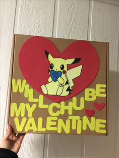 someone holding up a cardboard box with a cartoon pikachu on it that says will be my valentine