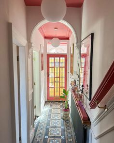 the hallway is decorated in pink and blue