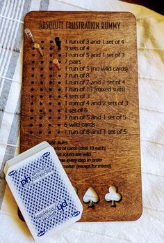 a wooden board with instructions on how to play the card game, and some other items