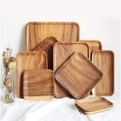 wooden plates and trays on a white surface