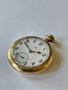 Omega Gold Filled White Two Level Two Tone Porcelain Dial Antique Pocket Watch Swiss Made In Great Working Condition, Keep Very Accurate Time. Just recently was serviced. Please have a look at our vintage watches we have constantly listed on Timeless White Pocket Watch For Formal Occasions, Classic White Pocket Watch For Formal Occasions, Pocket Watches, Vintage Gold Pocket Watch With Metal Dial, Vintage Yellow Gold Pocket Watch With Polished Finish, Vintage Hallmarked Yellow Gold Pocket Watch, Self-winding Yellow Gold Pocket Watch, Gold Clock, Antique Yellow Gold Self-winding Pocket Watch