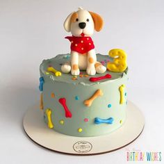 a birthday cake with a dog on top