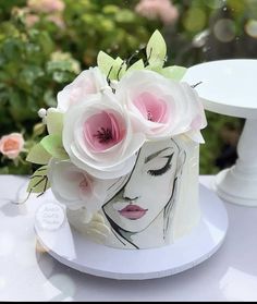 a white cake with pink flowers on top