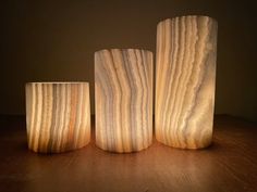 three wooden vases sitting on top of a table