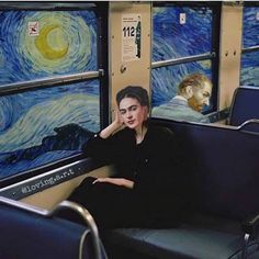 a woman sitting on a train seat next to the starry night painting behind her