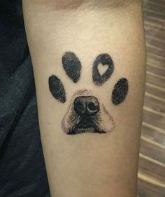 a dog's paw with hearts and paws on the left side of his arm