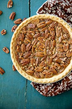 a pecan pie sitting on top of a blue table