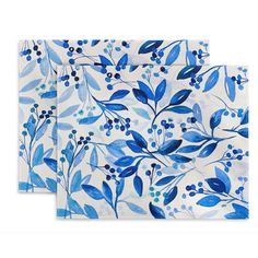 two napkins with blue leaves and berries on them