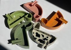 four different shaped cookie cutters sitting on top of a white table next to each other