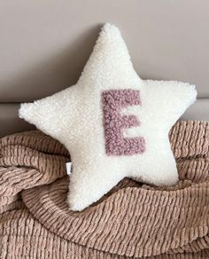 a star pillow with the letter e on it