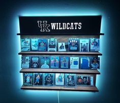 a wall mounted display with pictures and lights in the shape of wildcatss on it