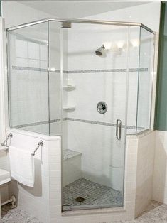 a bathroom with a walk in shower next to a toilet