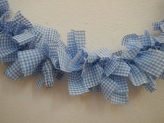 a blue and white checkered ribbon is hanging on the wall