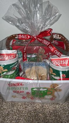 a basket filled with cookies and snacks on top of a carpeted floor next to a wall