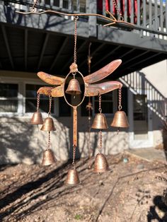 a metal wind chime with bells hanging from it