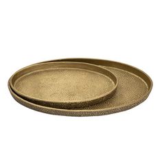 two brass trays sitting on top of each other