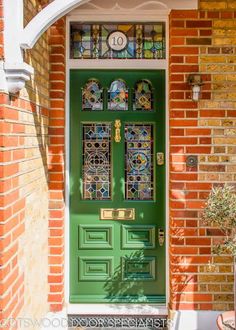 a green front door with stained glass windows