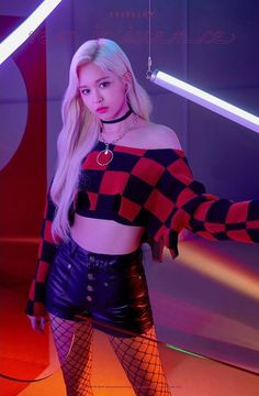 a woman with long blonde hair wearing fishnet stockings and tights, posing in front of neon lights