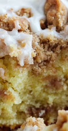 a close up of a piece of cake with icing and cinnamon crumbs