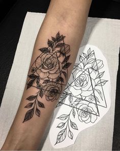 a woman's leg with tattoos on it and flowers in the middle of her arm