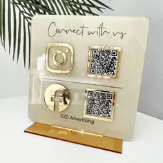 a white and gold plaque with qr - code on it that says connect us