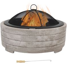 an outdoor fire pit is shown with the lid open and flames coming out from it