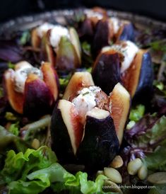 figs with goat cheese and nuts on a bed of lettuce