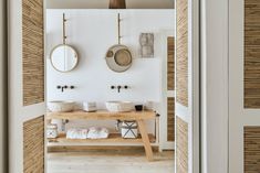 a bathroom with two sinks and mirrors on the wall