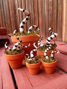 there are many black and white dalmatian figurines in the flower pots