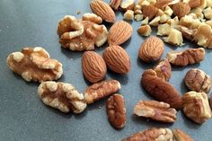 nuts are scattered on the table and ready to be eaten by someone who is eating them