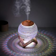 a smokestack sitting on top of a table next to an object with a wooden stick sticking out of it