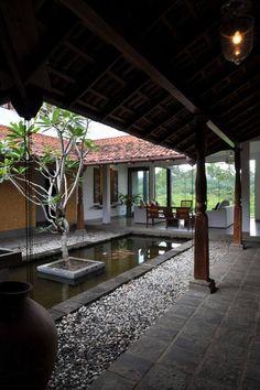 the inside of a house with a small pond