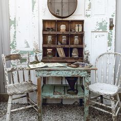 an old desk with two chairs next to it