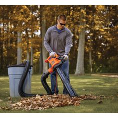 a man using a leaf blower to clean leaves