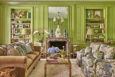 a living room filled with furniture and green walls