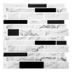 a white and black marble tile wall with some black squares on it's side