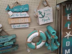 there are some signs and life preservers on the pegs in this store display