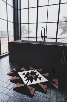 a bath tub sitting next to a large window