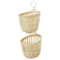 two wicker baskets hanging from the ceiling on white background with clipping for handles