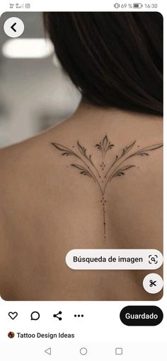 the back of a woman's shoulder with flowers on it