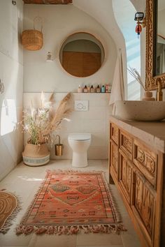 a bathroom with a rug, sink and toilet in it's centerpieces