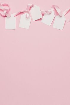 pink background with white tags and ribbons